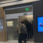 a group of people standing in front of a glass door