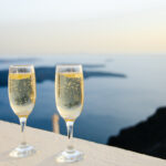 two glasses of champagne on a ledge