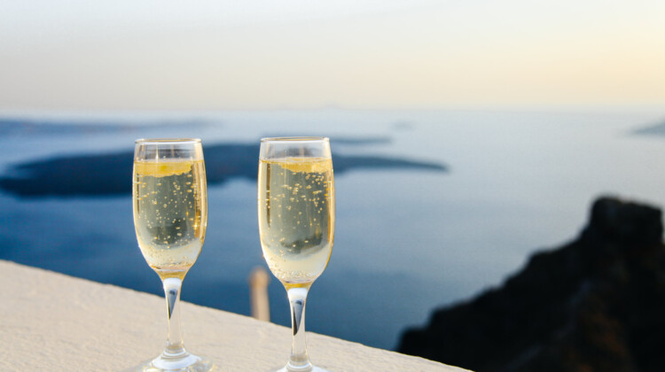 two glasses of champagne on a ledge