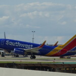 a blue and red airplane on a runway