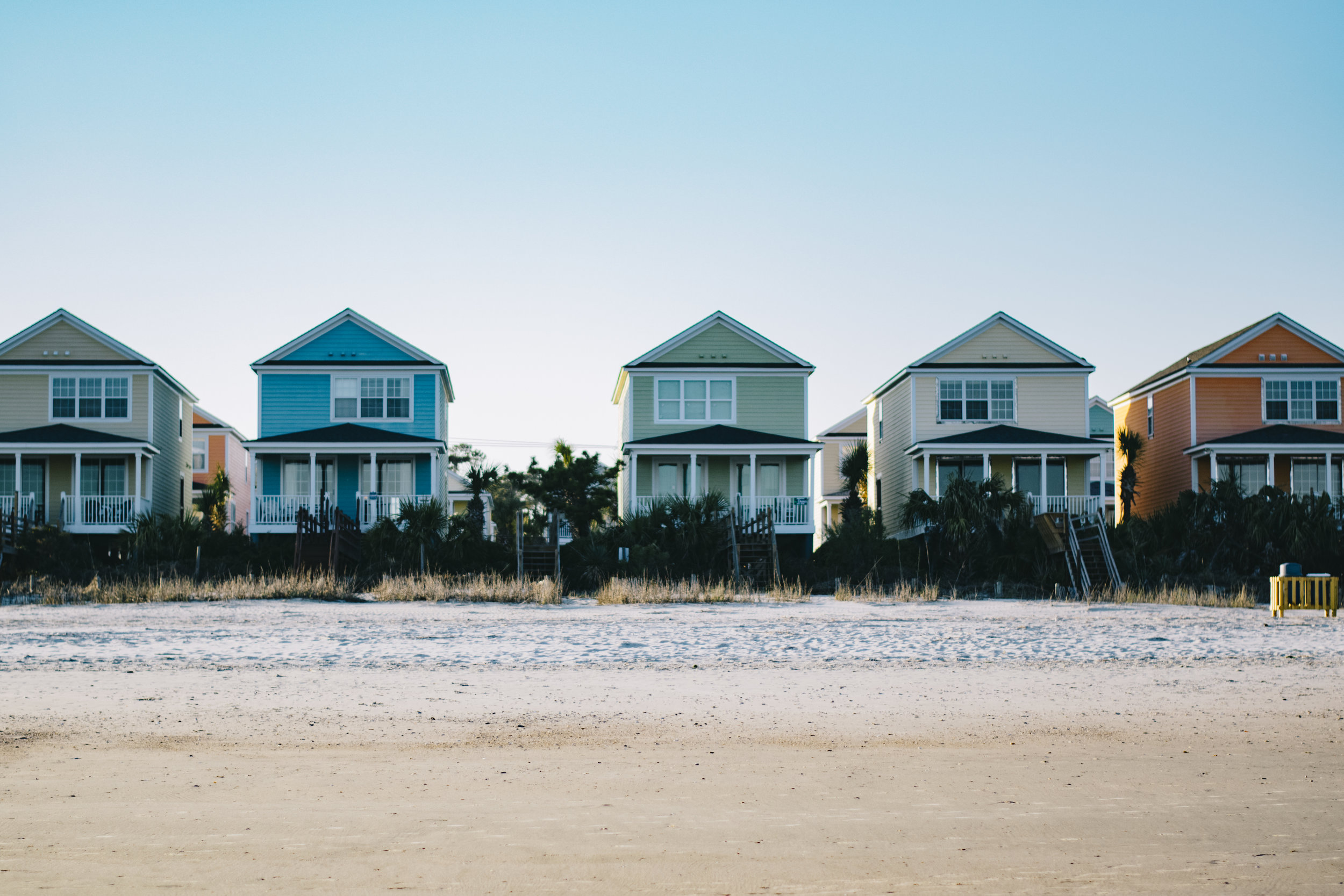 a row of houses on a beach
