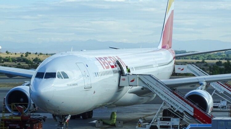 a large white airplane with red and yellow tail