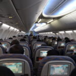 a group of people sitting in an airplane