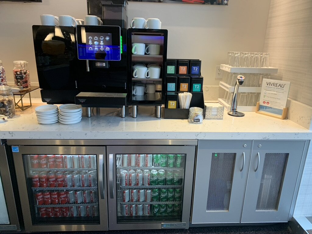 a coffee machine and beverage containers on a counter
