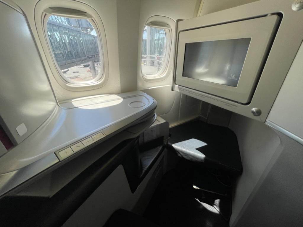 a tv and window in an airplane