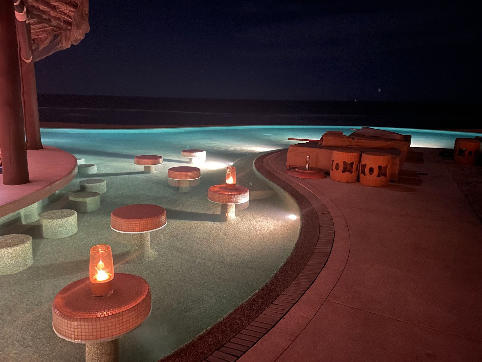 a pool with tables and candles