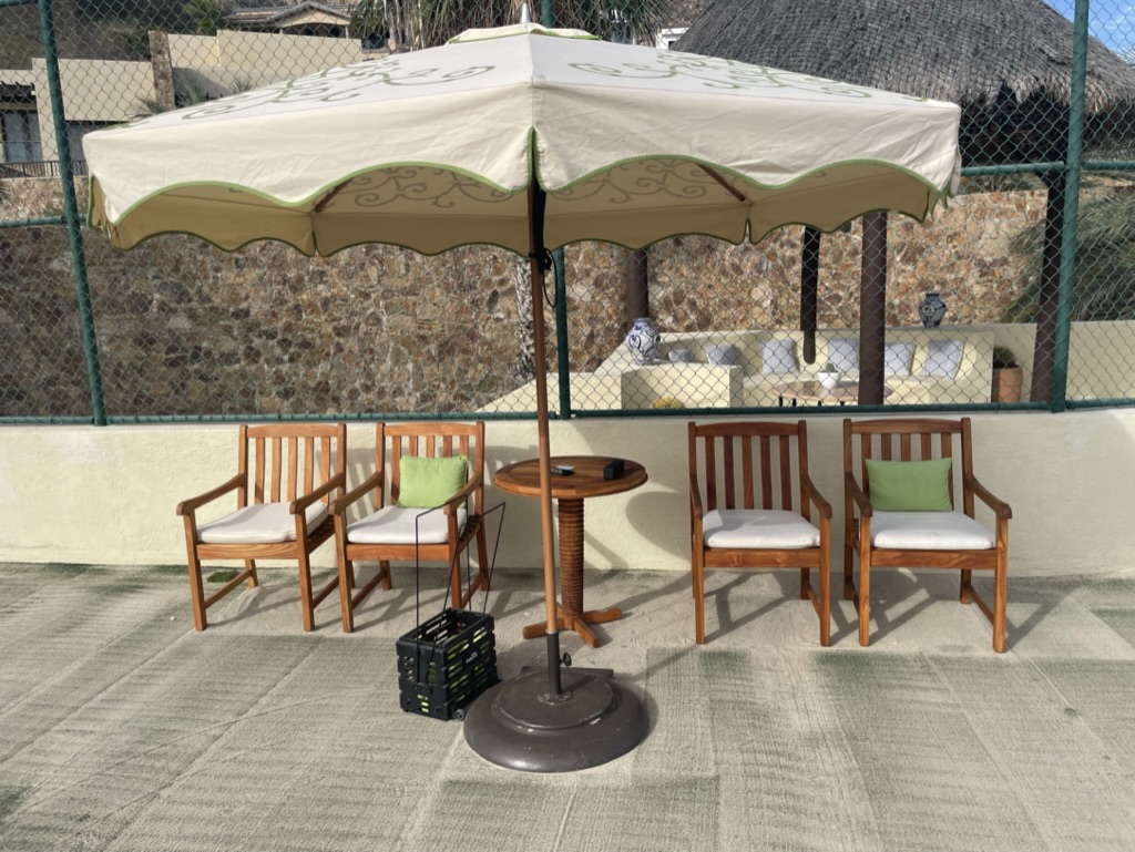 a table and chairs under an umbrella