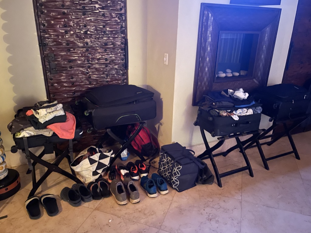 a group of luggage and shoes in a room
