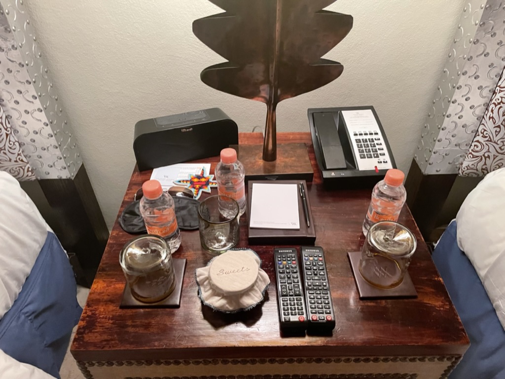 a table with a phone and glasses on it