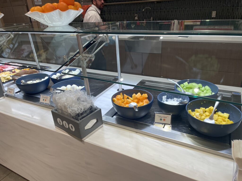 a display case with bowls of fruit