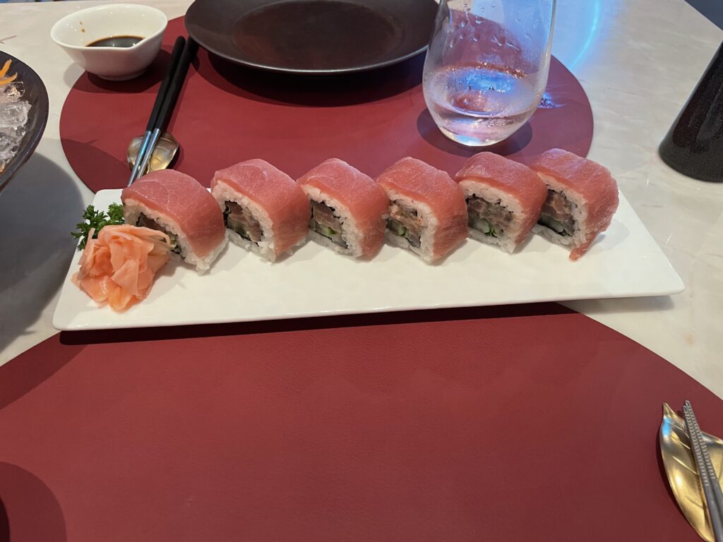a plate of sushi on a red table
