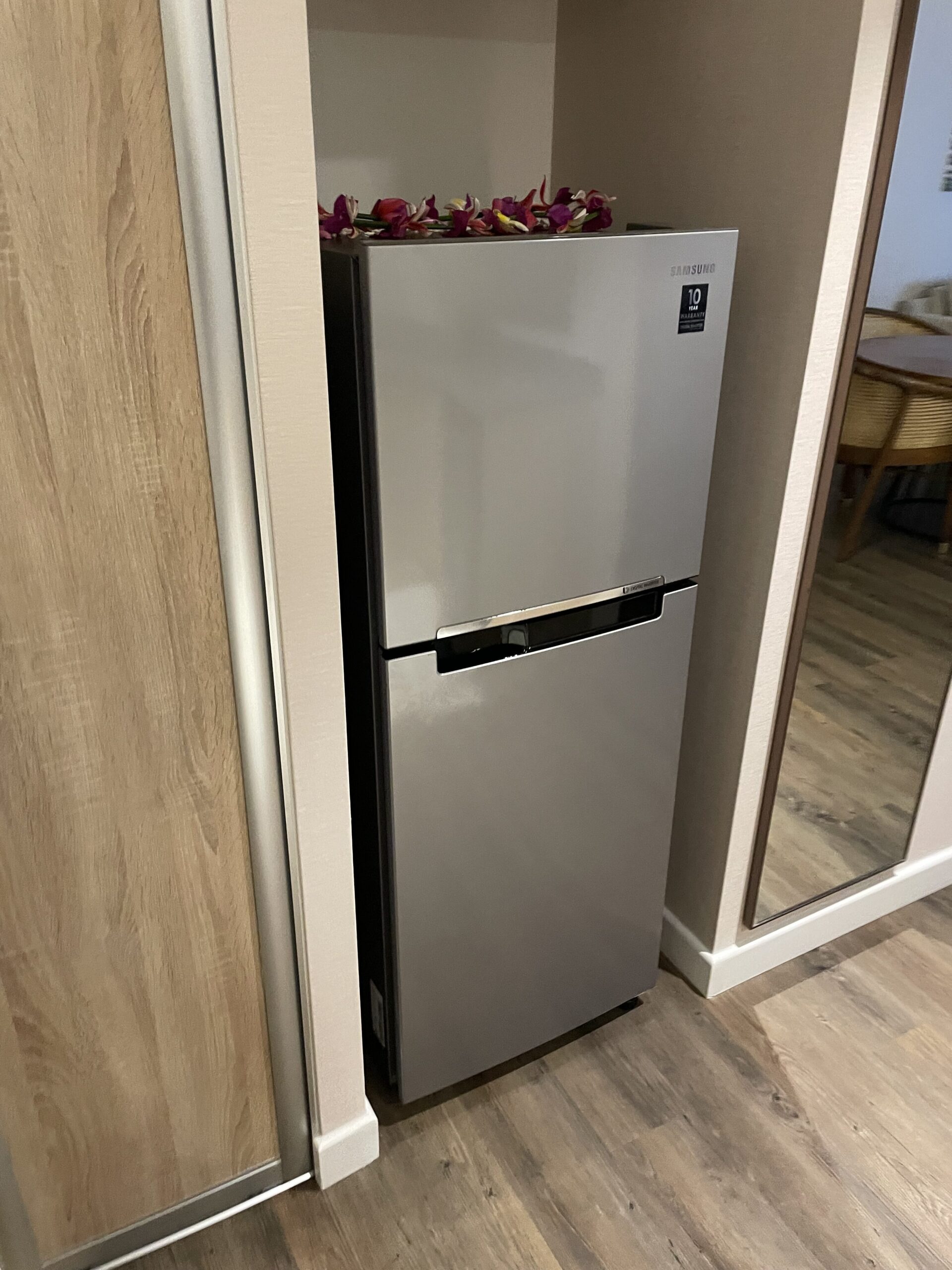 a refrigerator with flowers on top