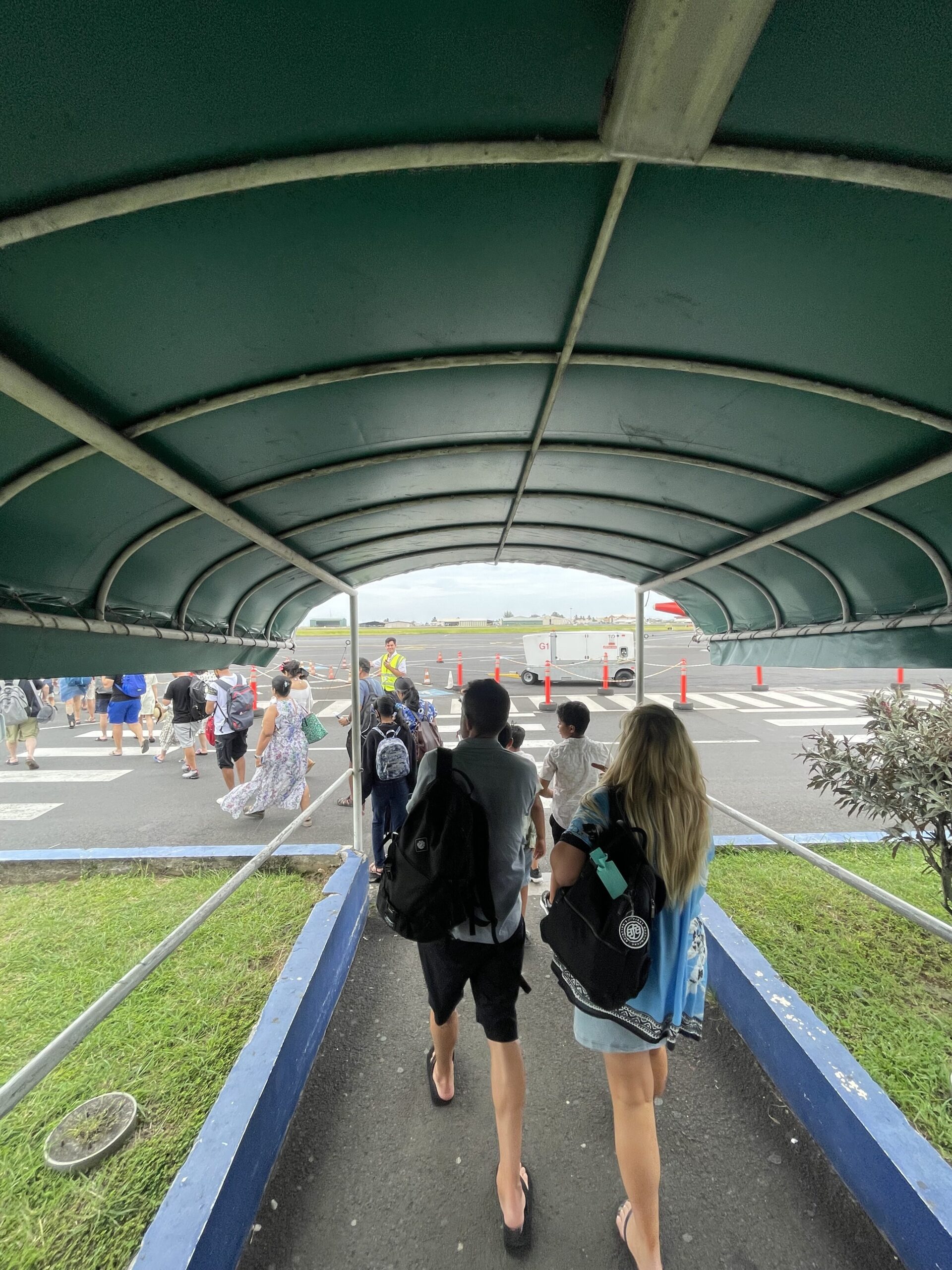 people walking under a canopy