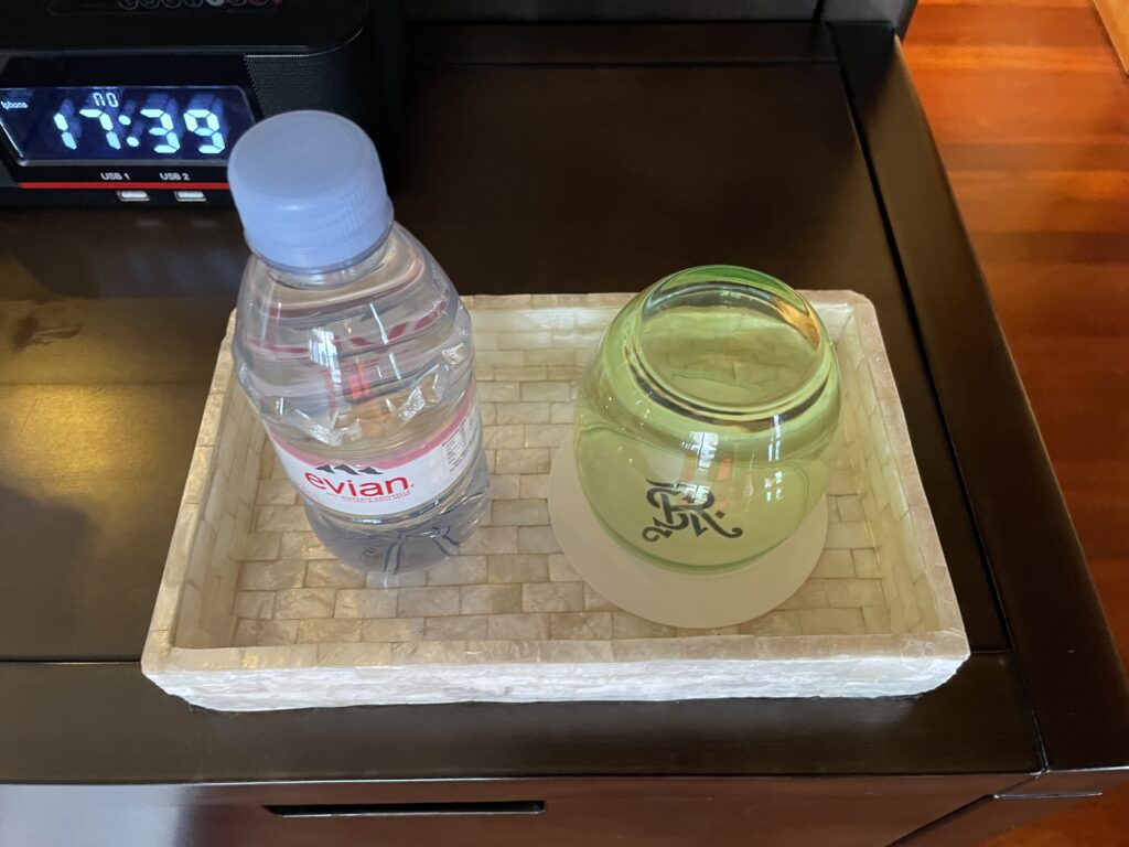 a bottle and glass on a tray