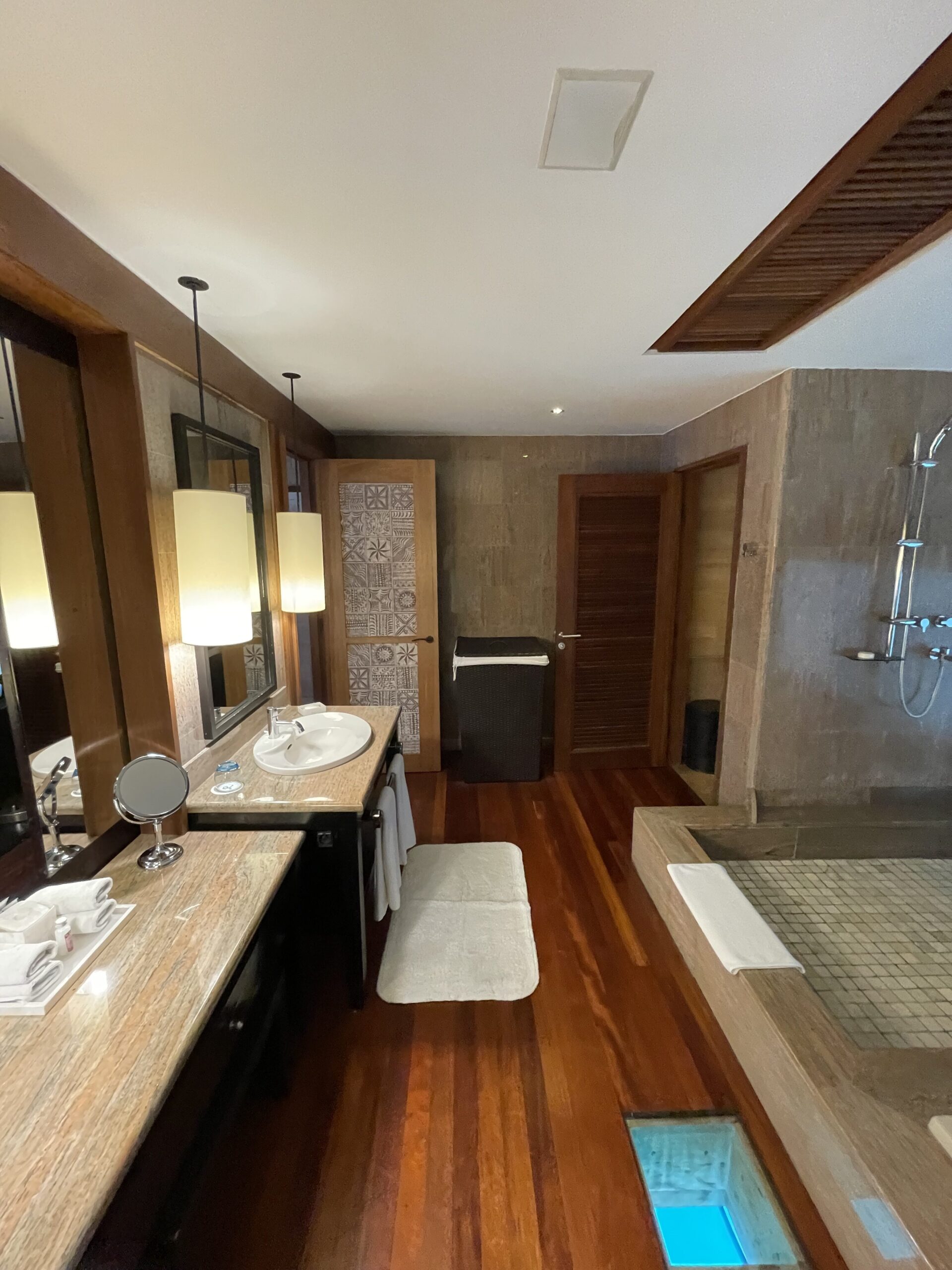 a bathroom with a wood floor and a shower