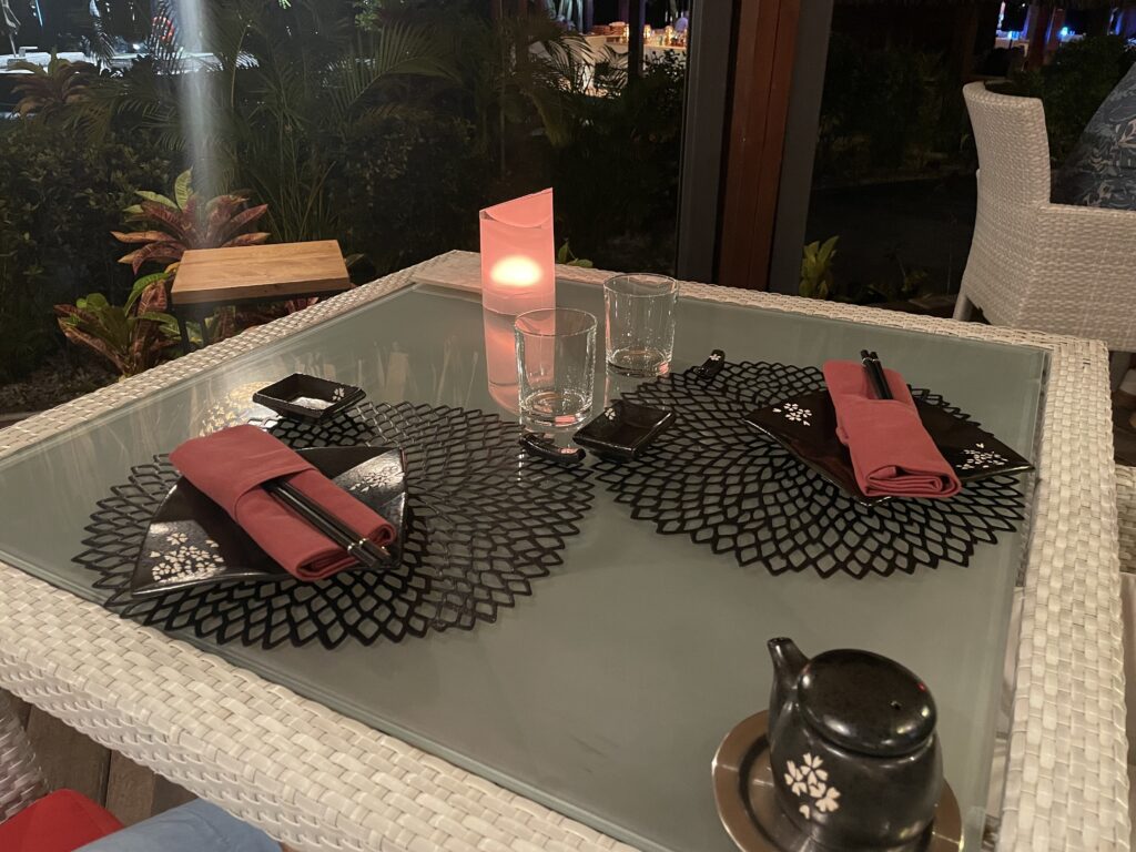 a table with a candle and glasses