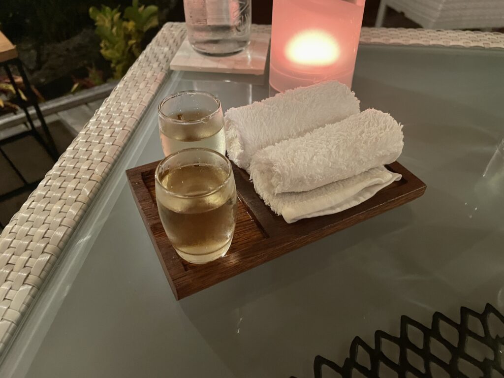 a tray of towels and glasses of liquid on a table