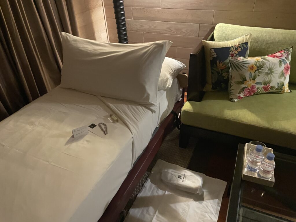 a two beds with pillows in a room
