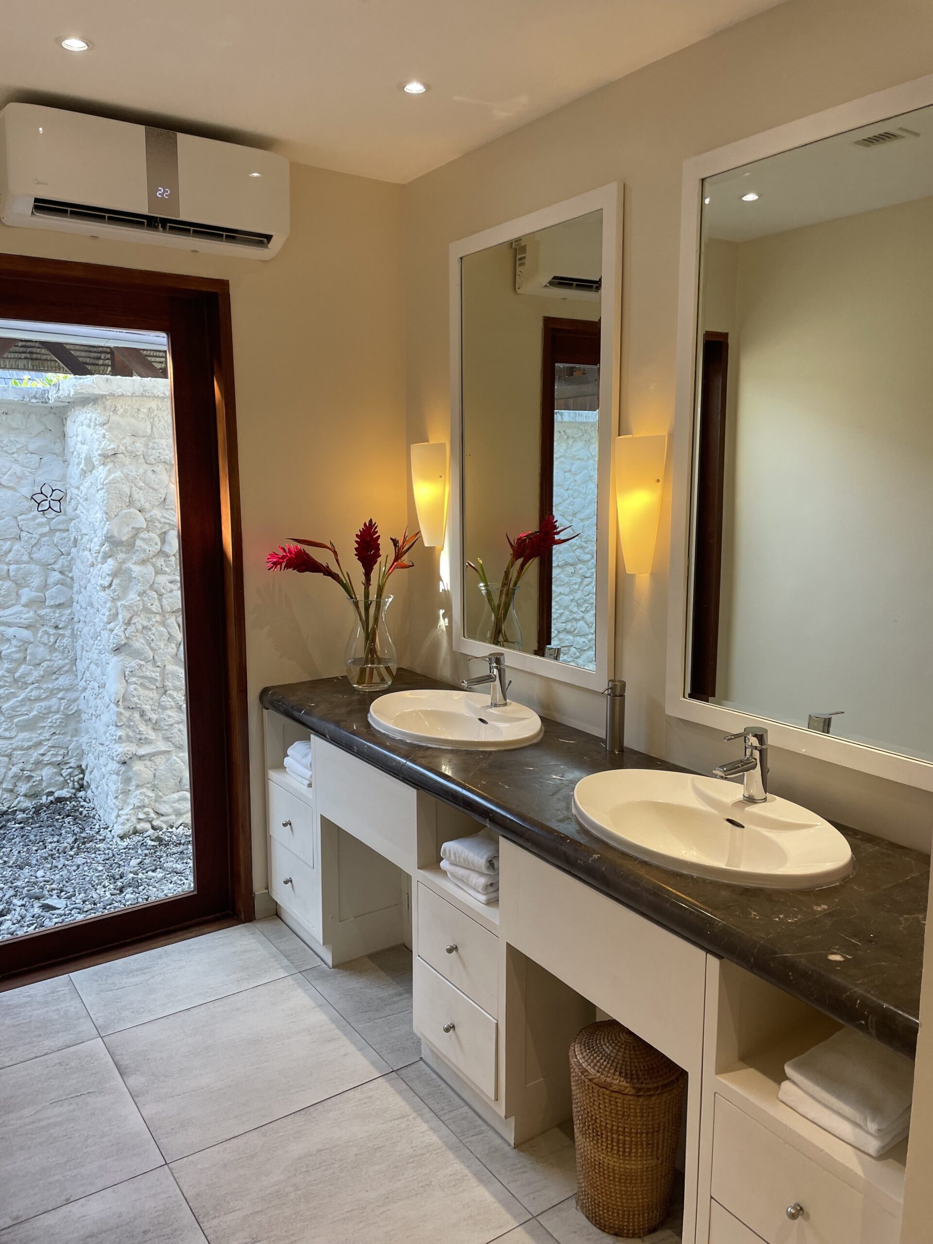 a bathroom with double sinks and mirrors