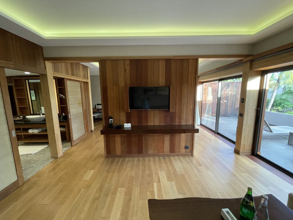 a room with a television and a wood floor