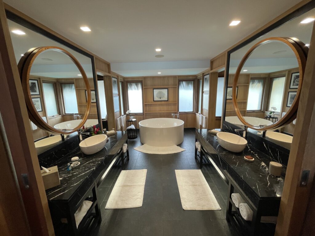 a bathroom with a large tub and double sinks