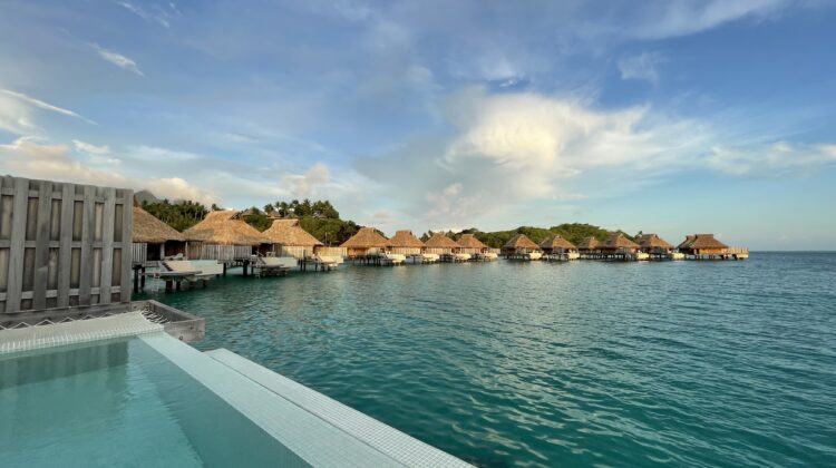 a pool with huts on the water