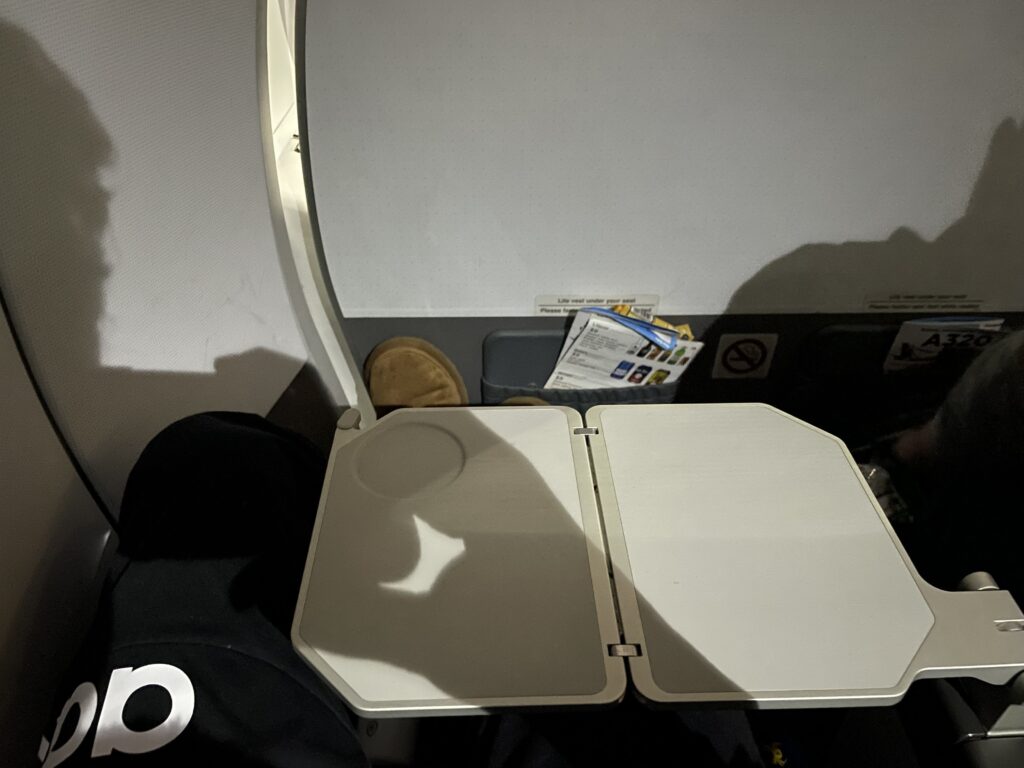 an airplane seat with a lid open