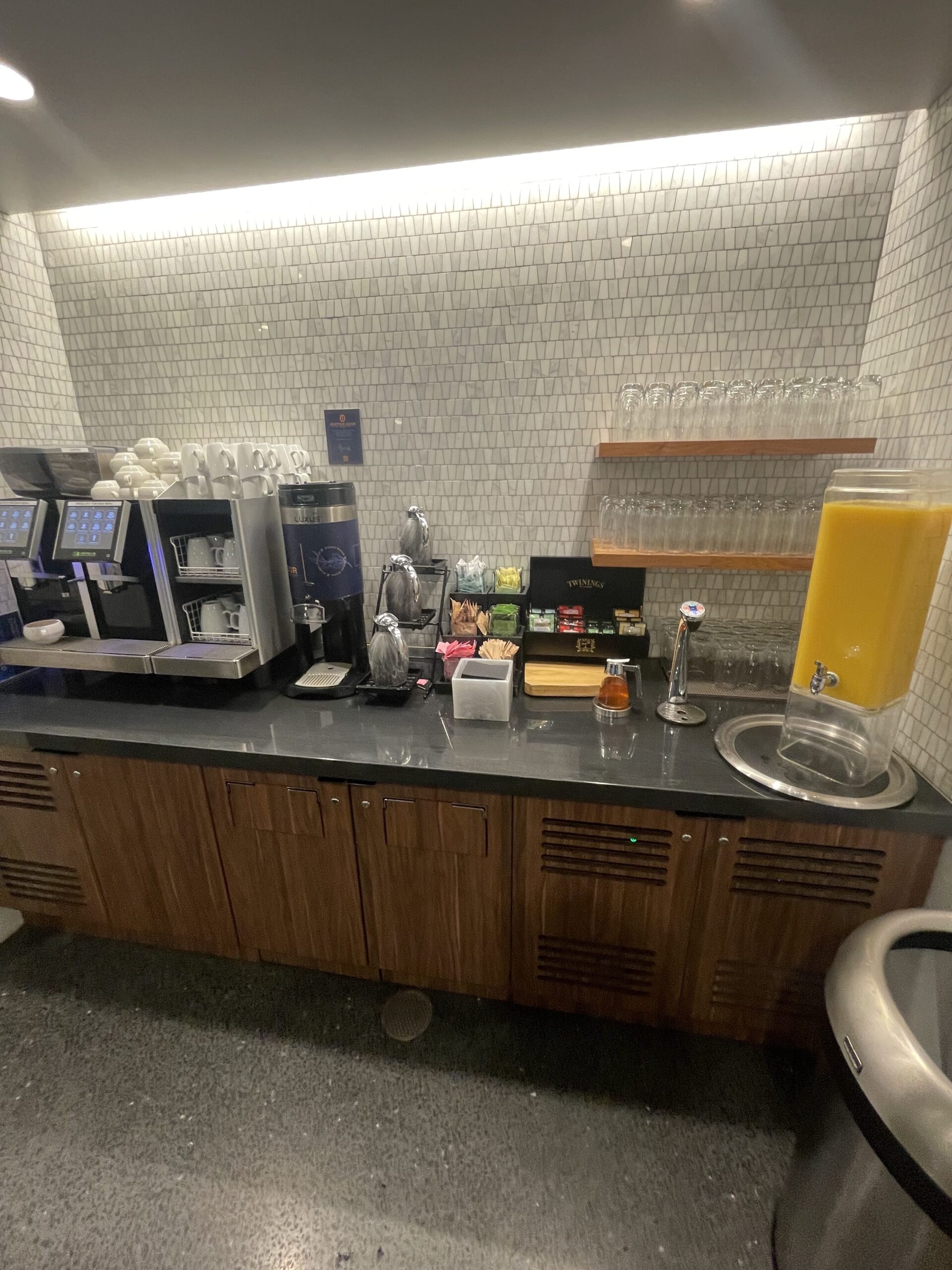 a coffee machine and juice dispenser on a counter