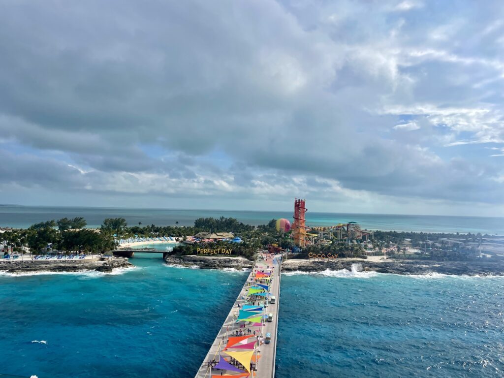 a long pier with a water park and a beach