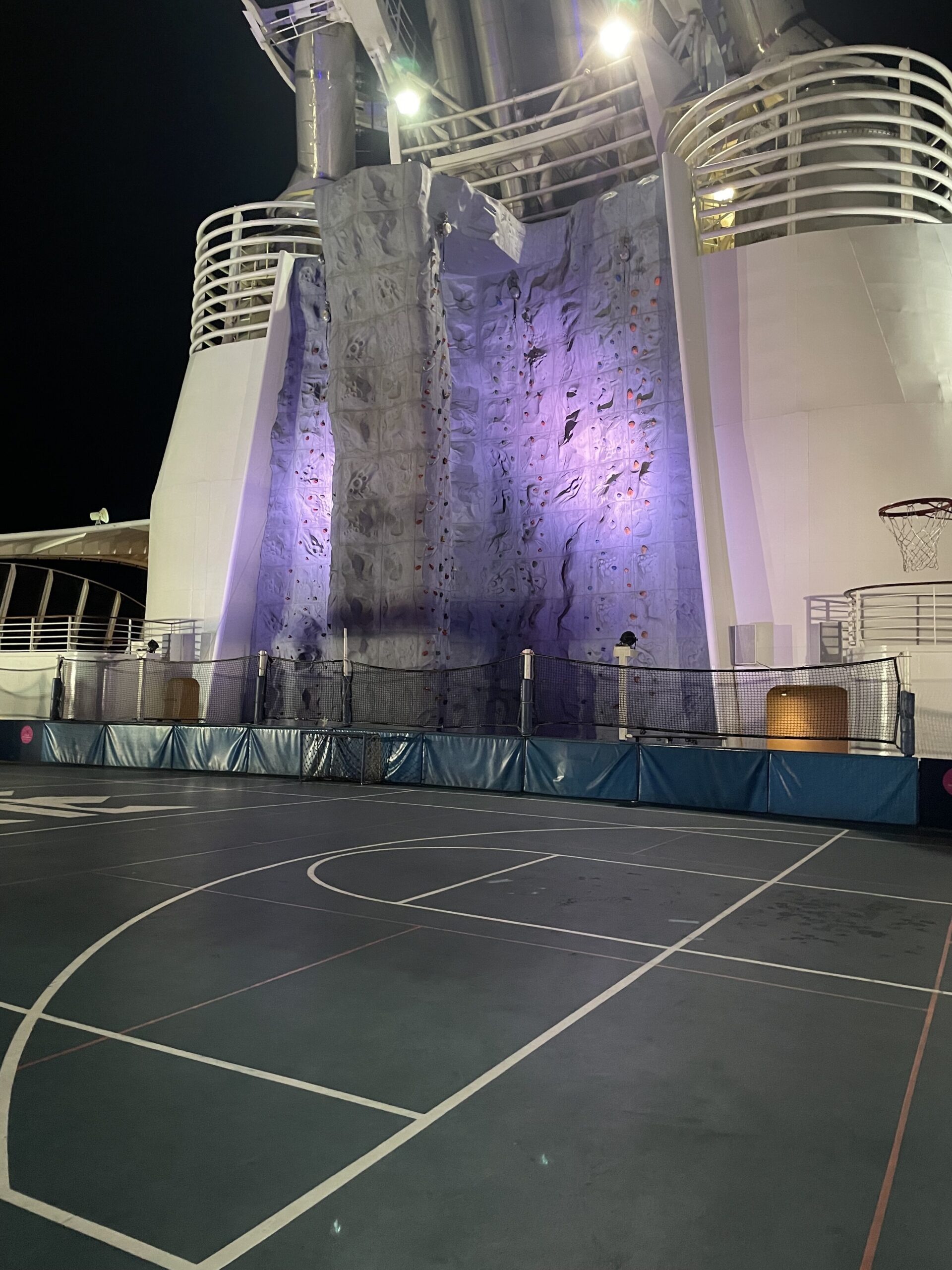 a basketball court with a climbing wall on a cruise ship