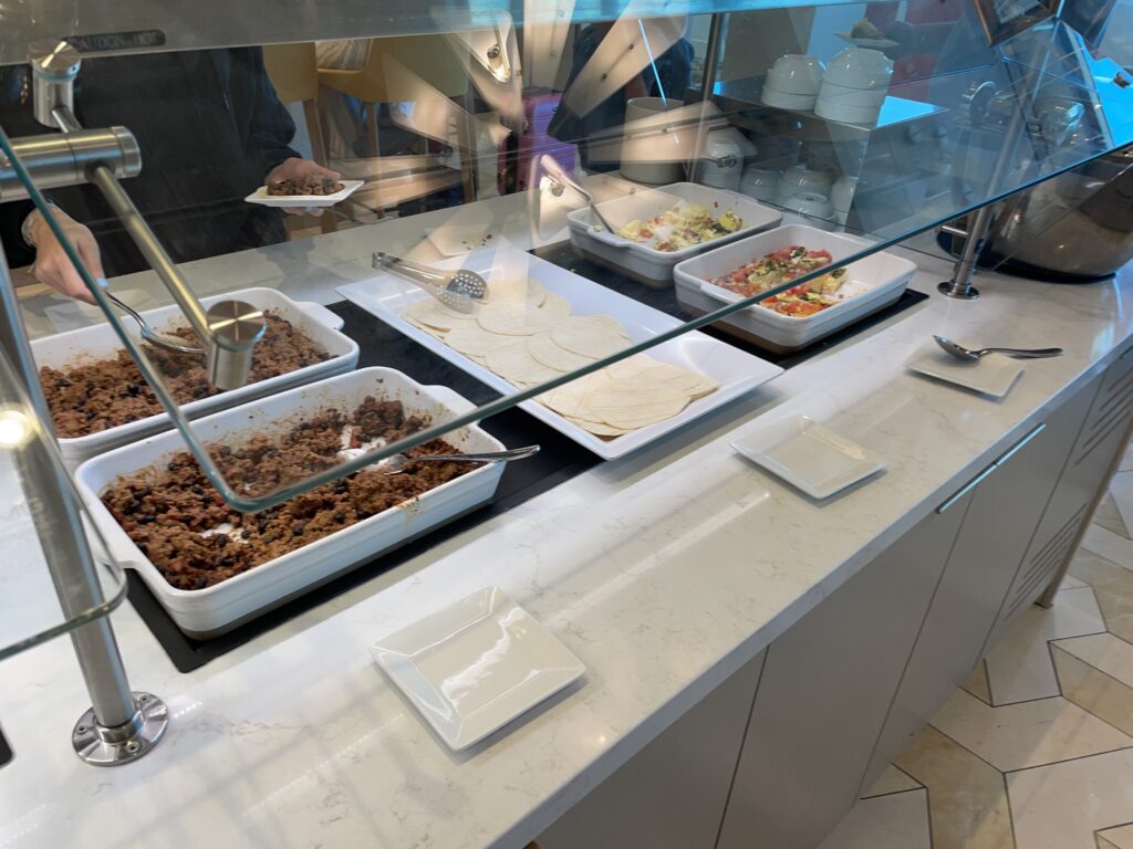 food in a buffet with a glass case