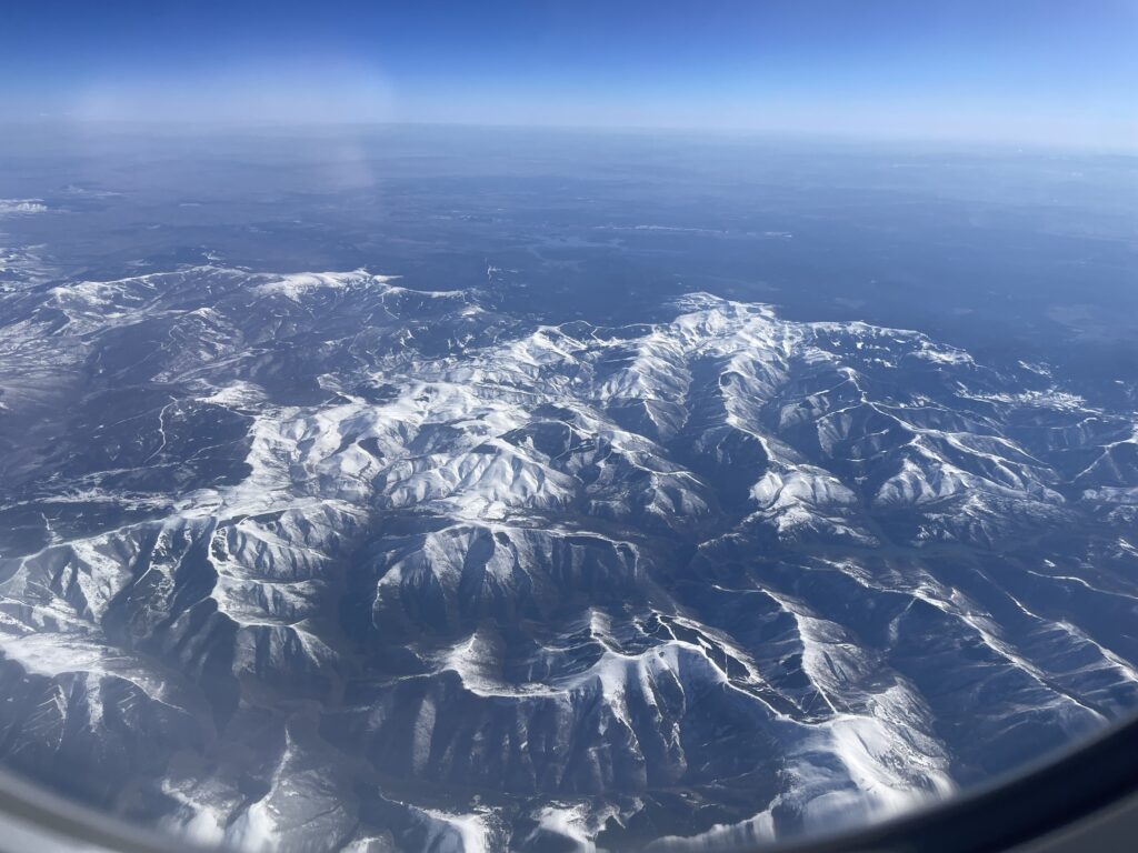 an aerial view of snowy mountains