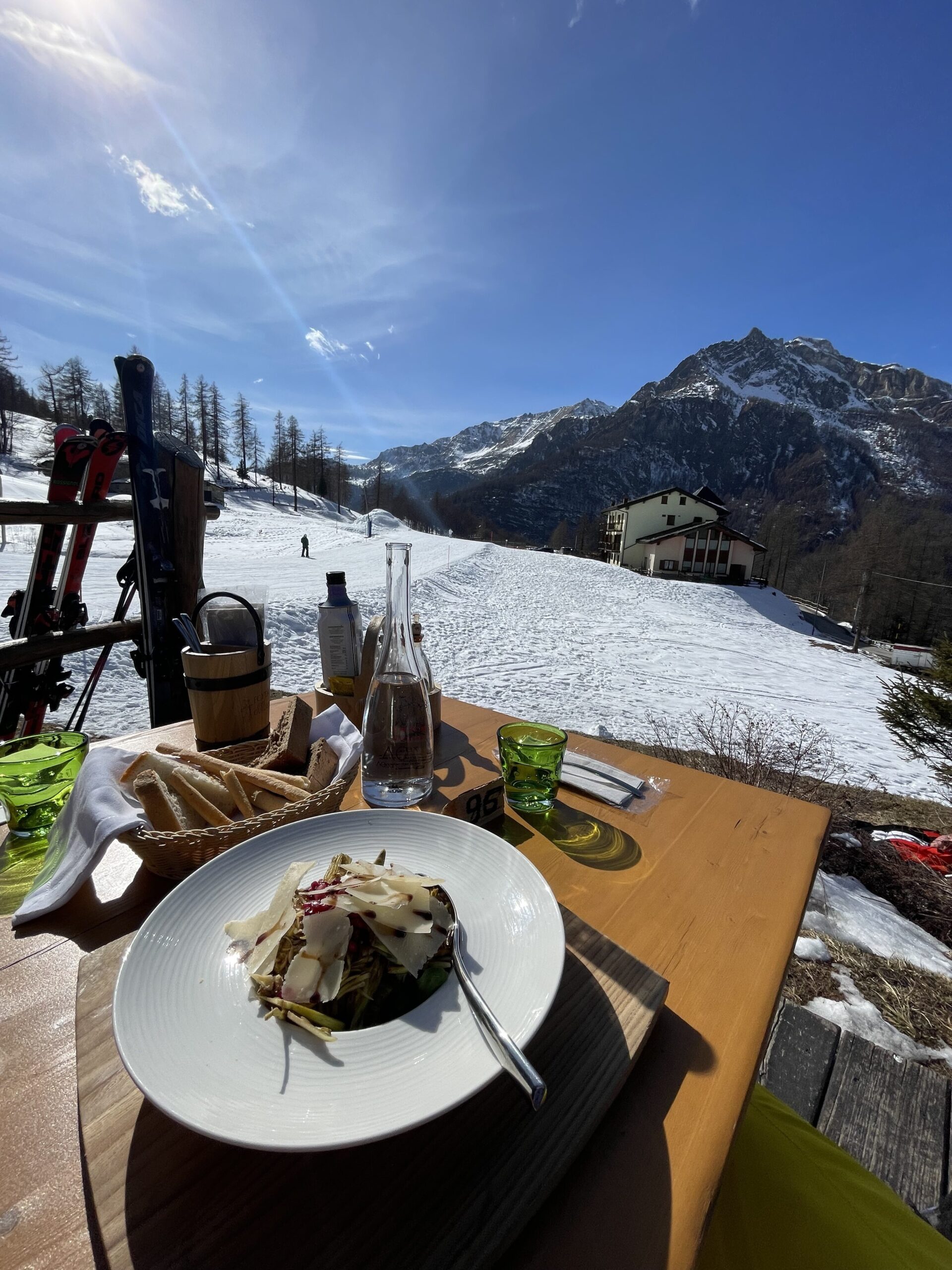 a table with food and drinks on it in the snow