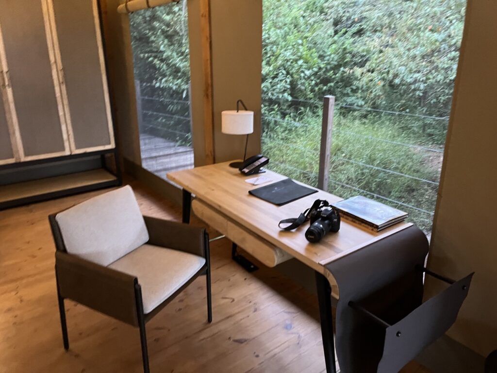 a desk with a camera and a chair