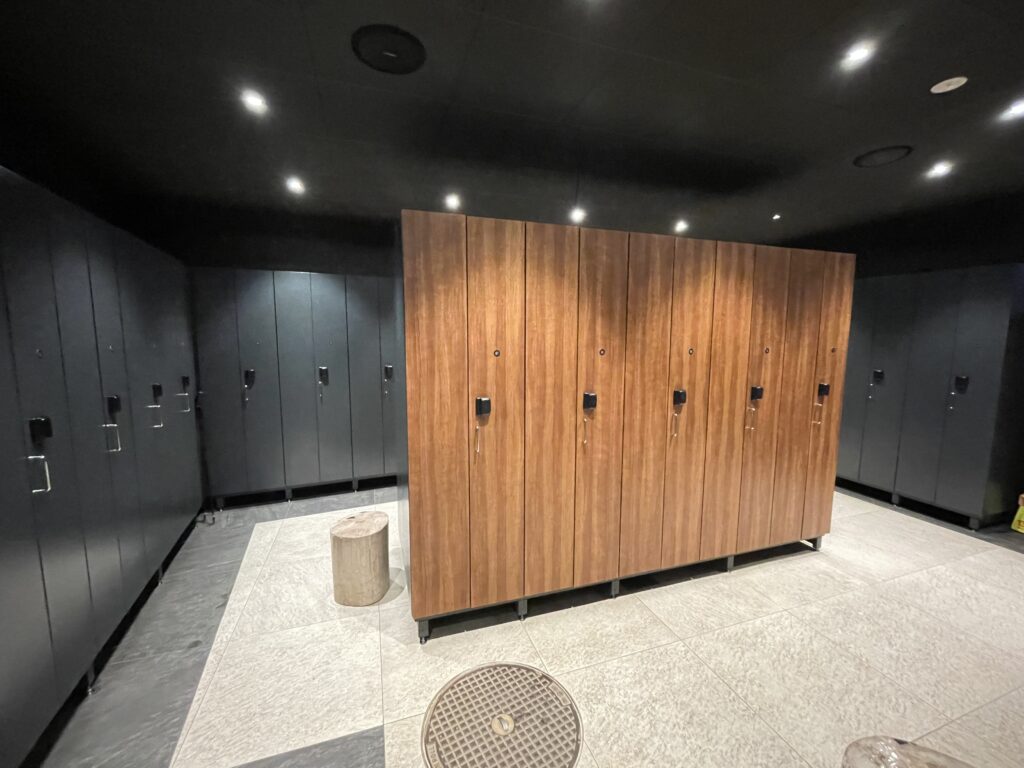 a locker room with black cabinets and a black ceiling