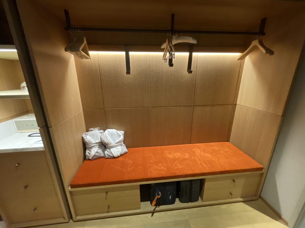 a closet with a bench and swingers