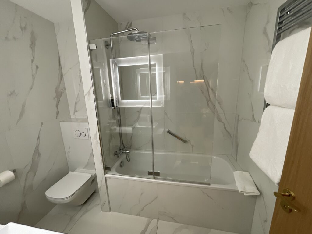 a bathroom with a glass shower and toilet