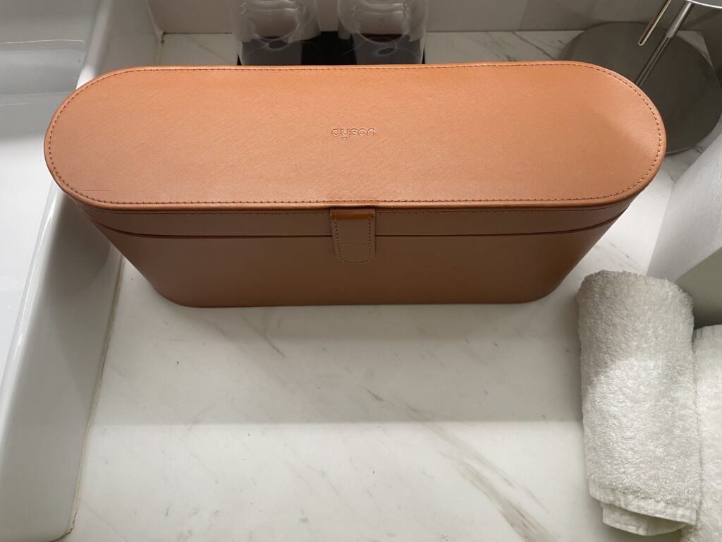a brown leather box on a marble counter