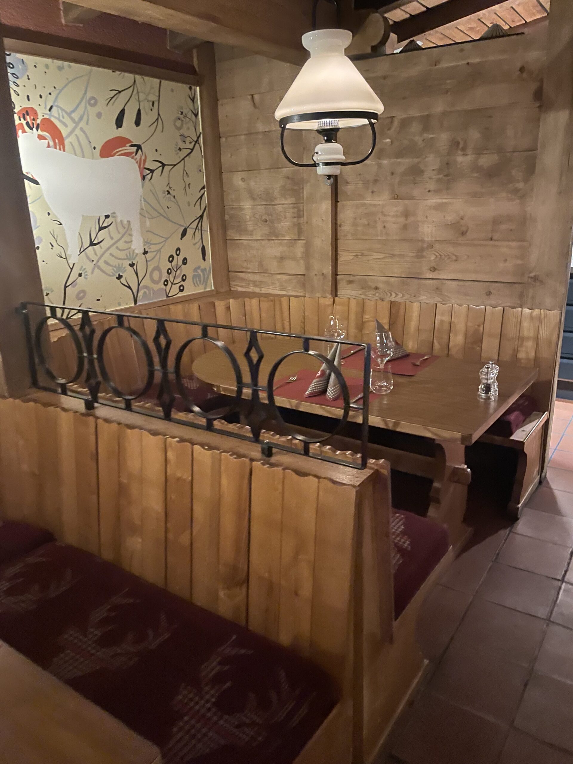 a wooden booth with a table and chairs
