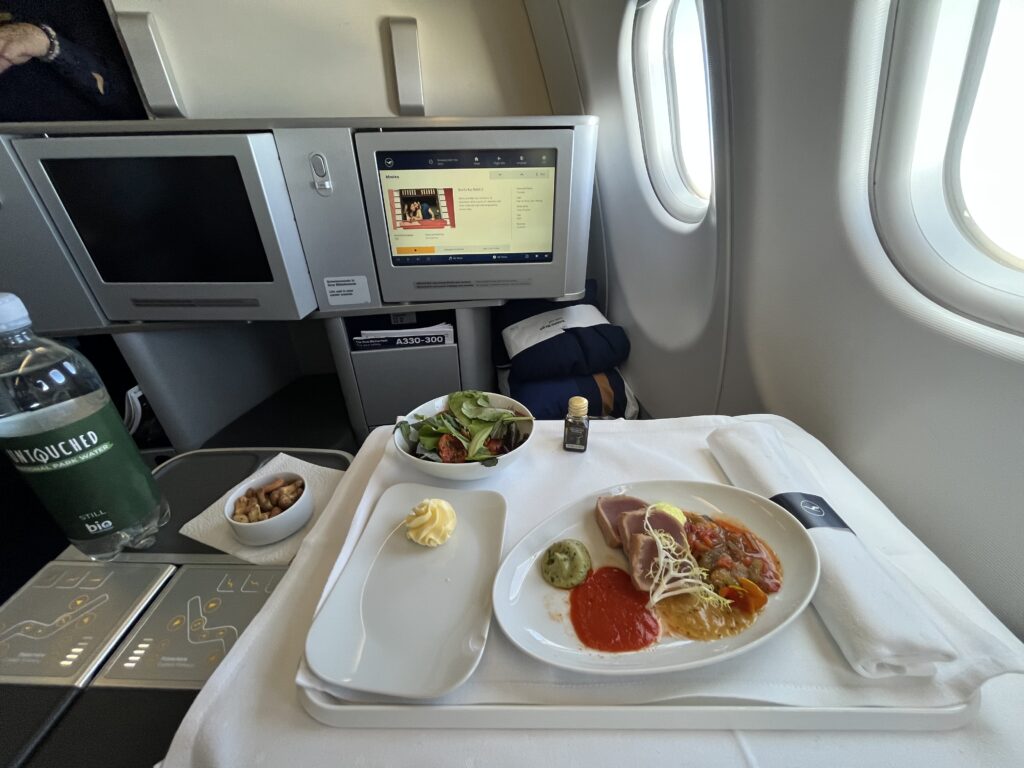 a plate of food on a tray in an airplane