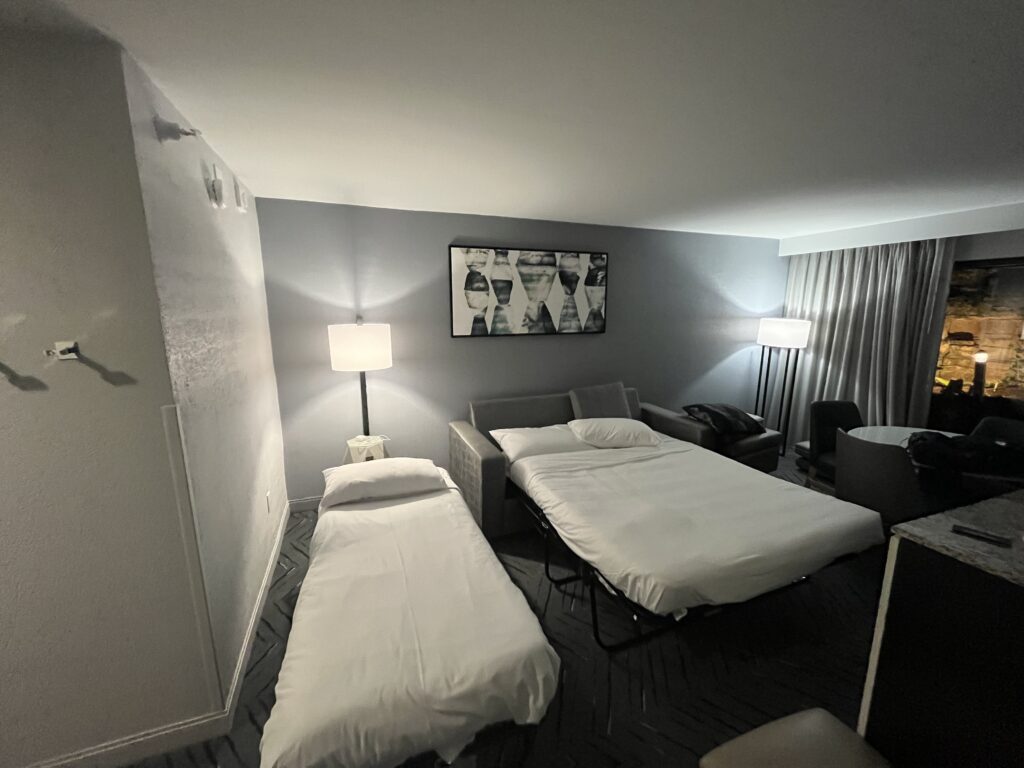 a room with two beds and a lamp