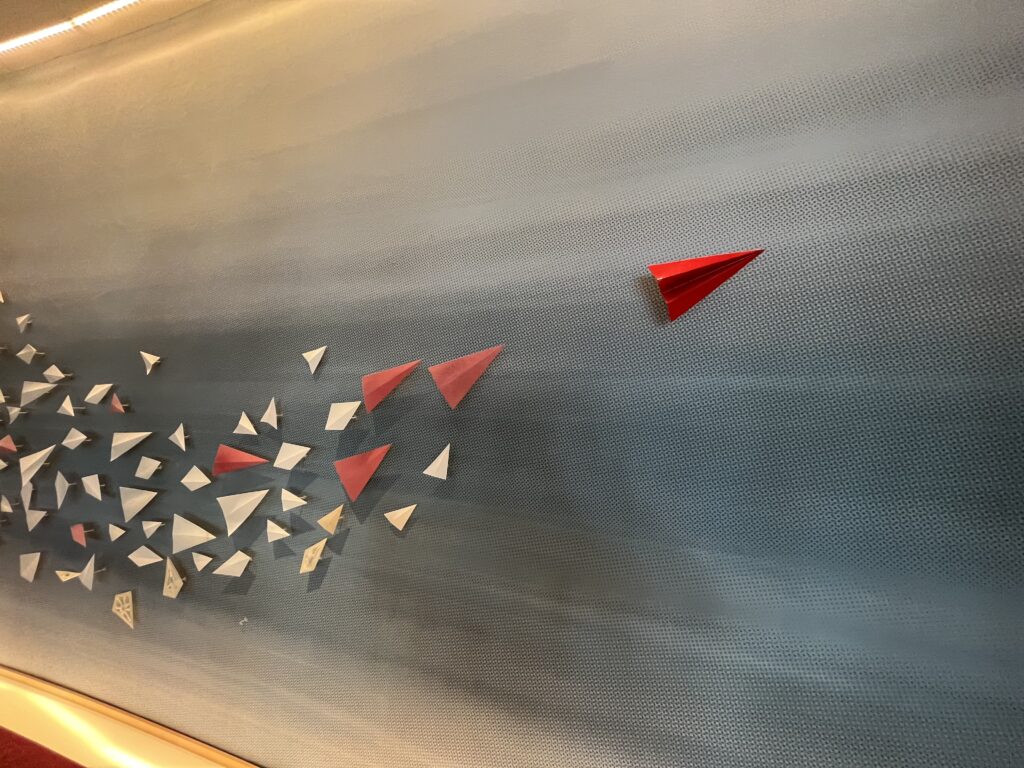 a group of paper planes on a wall