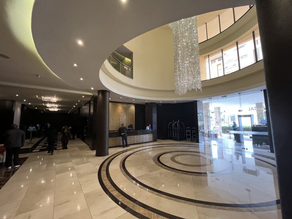a lobby with a large circular floor and a chandelier