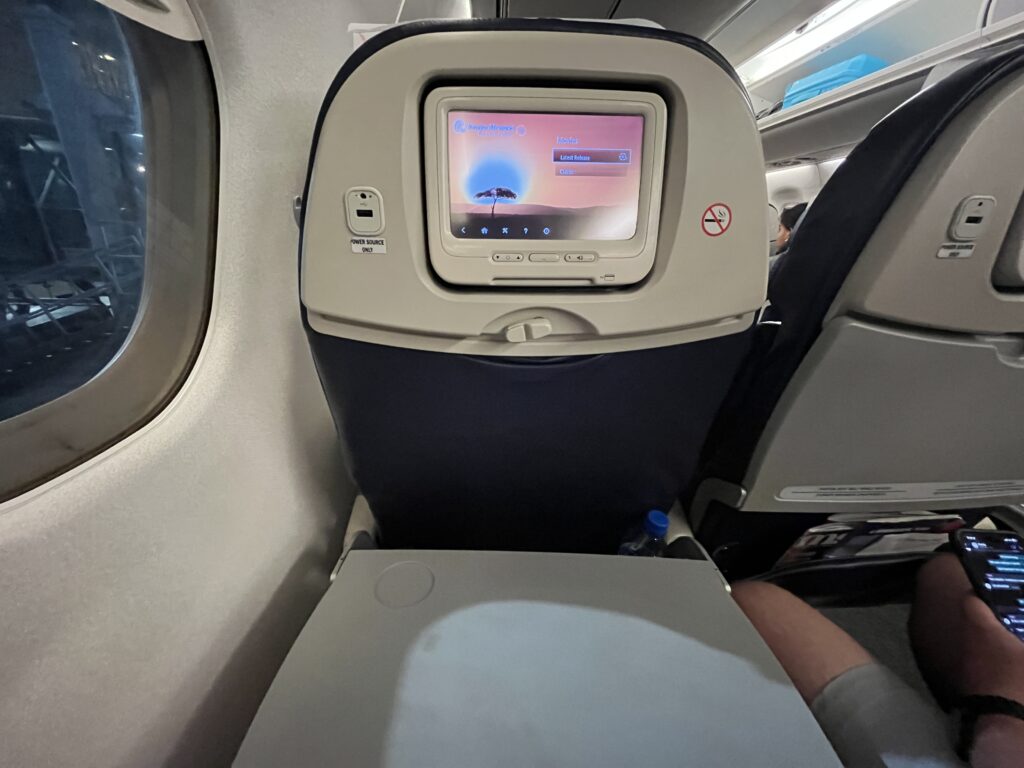 a screen on the seat of an airplane