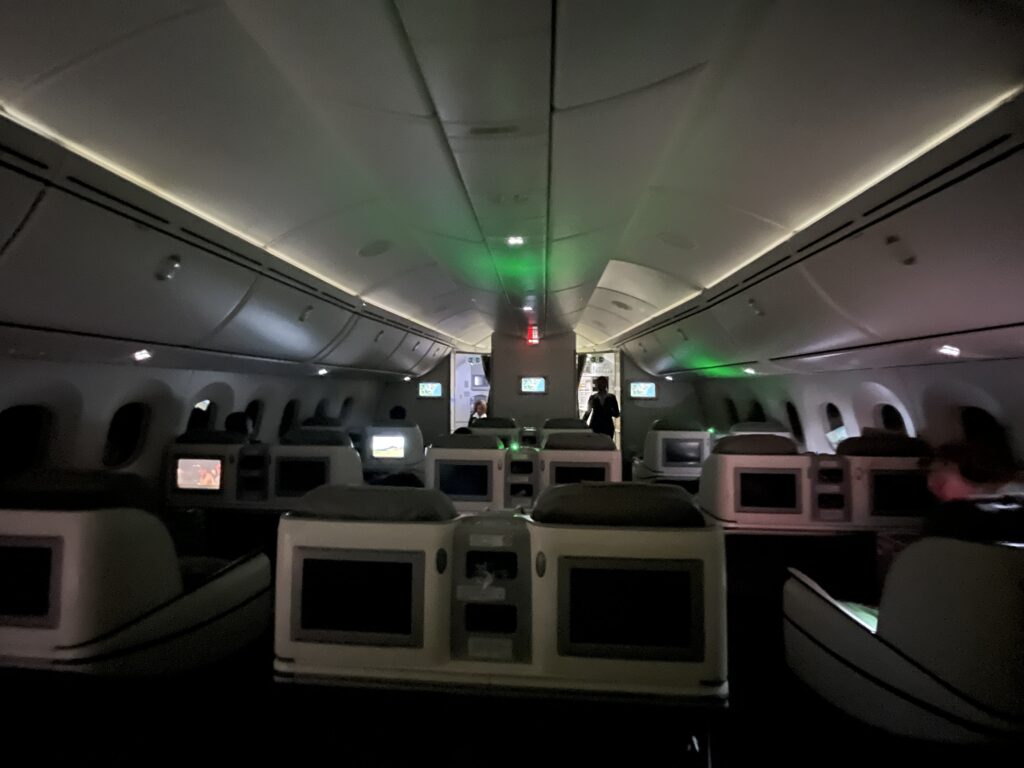 inside an airplane with rows of monitors