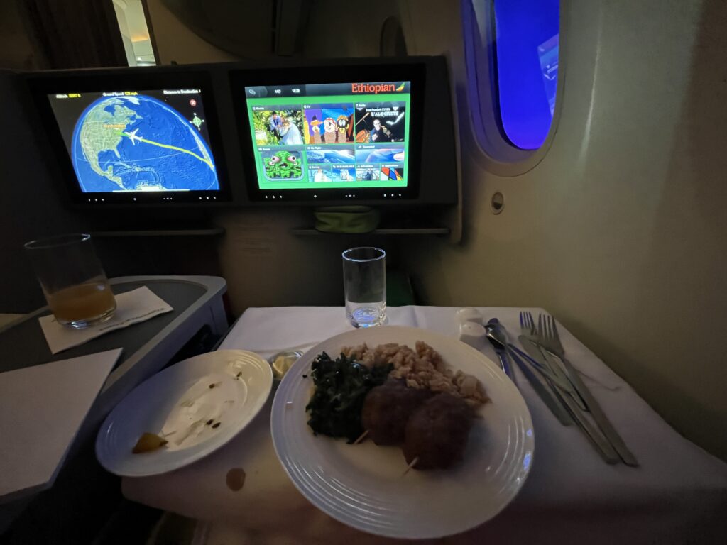 a plate of food on a table with two monitors