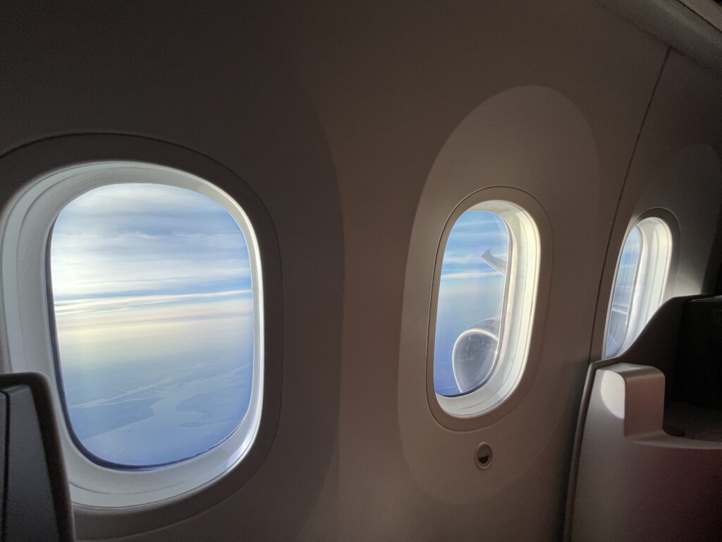 windows of an airplane with a view of the ocean