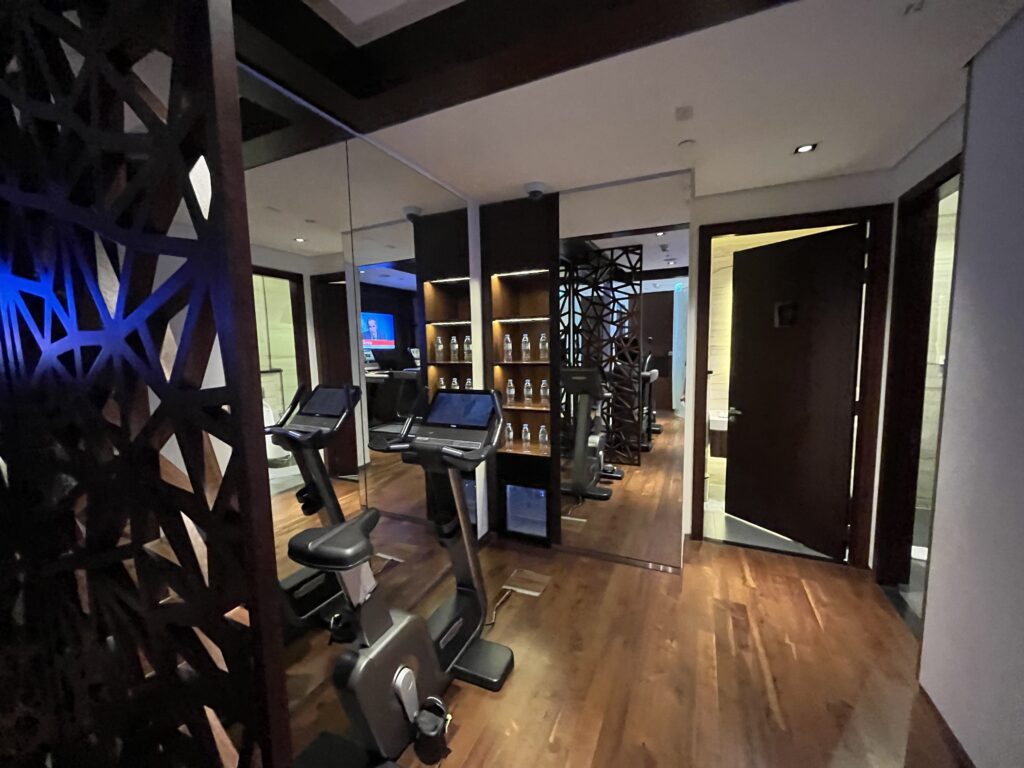 a room with exercise machines and a mirror