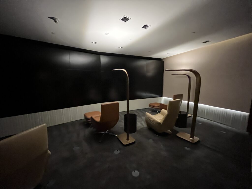 a room with chairs and a black wall